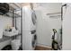 Modern laundry area with stacked washer and dryer and organized storage on a wire rack at 1750 Wewatta St # 605, Denver, CO 80202