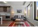 Inviting living room featuring modern kitchen, gray sofa, minimalist coffee table, and a large window with a city view at 1750 Wewatta St # 605, Denver, CO 80202