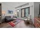 A well-lit living room showcases a comfortable sofa, modern chair, and colorful rug, complemented by city views at 1750 Wewatta St # 605, Denver, CO 80202