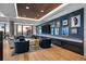Modern lounge area with stylish blue accent wall, ample seating, and large windows for natural light at 1750 Wewatta St # 605, Denver, CO 80202