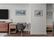 A modern office space features a sleek desk, comfortable chair, artwork, and ample natural light at 1750 Wewatta St # 605, Denver, CO 80202