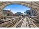 A train station features modern architecture, multiple tracks, and visible cityscape in a clear sky at 1750 Wewatta St # 605, Denver, CO 80202