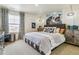 Modern bedroom with a large window, pug art, and a plush grey bed with decorative pillows and throws at 27756 E Byers Pl, Aurora, CO 80018