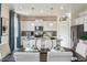 Elegant eat-in kitchen featuring white cabinets, stainless steel appliances, and attractive decor at 27756 E Byers Pl, Aurora, CO 80018