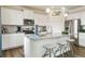Stylish kitchen featuring white cabinets, stainless steel appliances, a center island, and modern accents at 27756 E Byers Pl, Aurora, CO 80018
