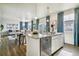Open floorplan showcasing kitchen with island and stainless appliances flowing into dining and living space at 27756 E Byers Pl, Aurora, CO 80018