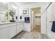 Modern main bathroom featuring double sinks, walk-in shower, and linen closet at 27756 E Byers Pl, Aurora, CO 80018