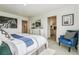Bright and inviting main bedroom with a plush blue chair and large window at 27756 E Byers Pl, Aurora, CO 80018