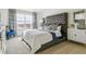 Serene bedroom with a large window, tufted headboard, and neutral tones at 27756 E Byers Pl, Aurora, CO 80018
