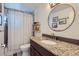 Well-lit bathroom with stylish vanity, granite countertop, and shower-tub combination at 5225 Balsam St # 1, Arvada, CO 80002