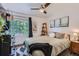 Cozy bedroom featuring a comfortable bed, dark wood accents, and natural light at 5225 Balsam St # 1, Arvada, CO 80002