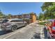 Exterior angle of condominium complex, rear view of private patio, and parking at 5225 Balsam St # 1, Arvada, CO 80002