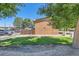 Brick building exterior featuring well-maintained landscaping and a wooden fence for added privacy at 5225 Balsam St # 1, Arvada, CO 80002