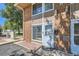 Exterior front entrance of home featuring brick facade, modern lighting, and well-kept walkway at 5225 Balsam St # 1, Arvada, CO 80002