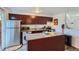 Bright kitchen with stainless steel appliances, granite counters, and convenient washer at 5225 Balsam St # 1, Arvada, CO 80002