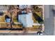 Bird's-eye view of the property with a fenced yard, mature trees, and a detached garage in a residential neighborhood at 705 Kenton St, Aurora, CO 80010