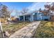 Spacious backyard with covered patio, laundry area, and well-maintained lawn at 705 Kenton St, Aurora, CO 80010