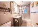 Bathroom featuring tiled floors, vanity with storage, and shower-tub combination at 705 Kenton St, Aurora, CO 80010