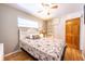 Comfortable bedroom with hardwood floors, white storage, and warm lighting at 705 Kenton St, Aurora, CO 80010