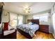 Bright bedroom featuring hardwood floors, large windows, and access to the backyard at 705 Kenton St, Aurora, CO 80010