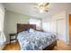 Spacious bedroom with hardwood floors, closet storage, and modern ceiling fan at 705 Kenton St, Aurora, CO 80010