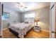 Cozy bedroom with hardwood floors, ceiling fan, and a quaint window at 705 Kenton St, Aurora, CO 80010