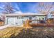 Charming light blue home with a cozy front porch and well-maintained lawn at 705 Kenton St, Aurora, CO 80010