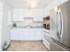 Clean kitchen featuring stainless steel appliances, white cabinets and subway tile backsplash at 705 Kenton St, Aurora, CO 80010
