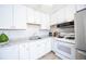 Well-lit kitchen with stainless steel appliances and white cabinetry at 705 Kenton St, Aurora, CO 80010
