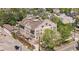 Aerial view of building with brown roof, many windows, and surrounded by lush trees at 108 W Byers Pl # G1, Denver, CO 80223