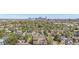 Wide aerial view of residential area, tree lined streets, city skyline in the background at 108 W Byers Pl # G1, Denver, CO 80223
