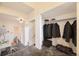 A carpeted foyer offers closet storage and built in office space under the staircase at 108 W Byers Pl # G1, Denver, CO 80223