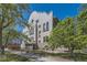 Elegant apartment building surrounded by mature trees and lush landscaping at 108 W Byers Pl # G1, Denver, CO 80223