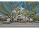 Handsome brick apartment building framed by mature trees on a beautiful day at 108 W Byers Pl # G1, Denver, CO 80223