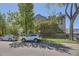 Street view of a handsome brick apartment building with mature trees and green lawn at 108 W Byers Pl # G1, Denver, CO 80223