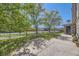 Property with a manicured lawn, mature trees, and black iron fence, enhancing its curb appeal at 108 W Byers Pl # G1, Denver, CO 80223