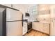 Updated kitchen with stainless steel appliances, white cabinets, and stylish backsplash at 108 W Byers Pl # G1, Denver, CO 80223