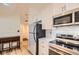 Bright kitchen features stainless steel appliances, white cabinets and marble countertops at 108 W Byers Pl # G1, Denver, CO 80223