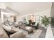 Spacious living room with plush gray seating, decorative pillows, and a leafy green houseplant at 108 W Byers Pl # G1, Denver, CO 80223