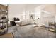 A neutral living room has white walls, carpeted floors, and several windows for natural light at 108 W Byers Pl # G1, Denver, CO 80223