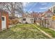 Spacious backyard with a shed, grassy area, garden, and wooden fence at 130 S Corona St, Denver, CO 80209