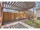 Inviting backyard patio with pergola, wooden fence, and shade from mature tree at 130 S Corona St, Denver, CO 80209