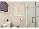 Modern bathroom featuring a glass shower, white tiled walls, and stylish fixtures at 130 S Corona St, Denver, CO 80209