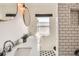 Modern bathroom featuring dual sinks, marble countertop, a glass shower, and stylish fixtures at 130 S Corona St, Denver, CO 80209