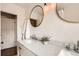 Bright bathroom features double vanity, marble countertops and updated fixtures at 130 S Corona St, Denver, CO 80209