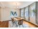 This gorgeous dining room features a wood table, modern light fixture and several large windows at 130 S Corona St, Denver, CO 80209
