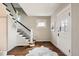 Bright entryway featuring hardwood floors, staircase, and a decorative front door at 130 S Corona St, Denver, CO 80209