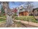 Street view of a two-story brick home and manicured lawn at 130 S Corona St, Denver, CO 80209