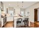 Bright eat-in kitchen featuring an island with marble countertops, stainless appliances, and hardwood flooring at 130 S Corona St, Denver, CO 80209