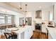 Open concept kitchen features an island with marble countertops, stainless appliances, and hardwood flooring at 130 S Corona St, Denver, CO 80209